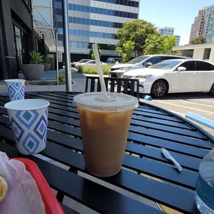 a cup of coffee and a sandwich on a table