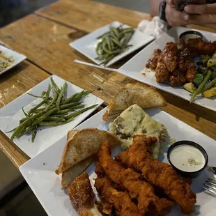 Chicken Tenders tossed in spicy buffalo and another tossed in Jamaican jerk