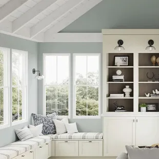 A cozy living room featuring painted vanilla cabinetry, open shelving, and a fireplace creates a warm and inviting atmosphere!