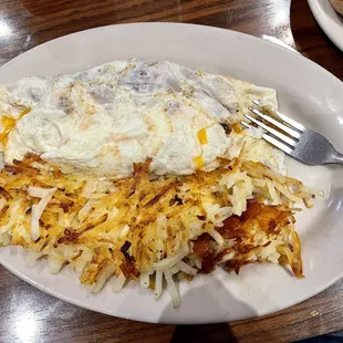 Egg white omelette with mushrooms, bacon, and cheese. And hash browns