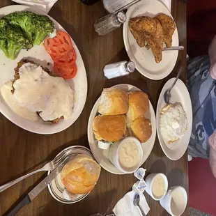 Country fried steak, biscuits and gravy, pork chops, eggs topped with grits