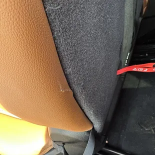Here is one of the tears and my seat stuck forward before they crammed it down into place ruining the entire frame.
