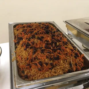 Rice with goat meat and caramelized carrots and raisins , almonds , very tasty