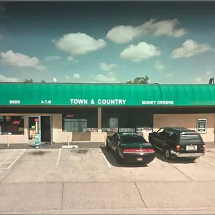 two cars parked in front of a store