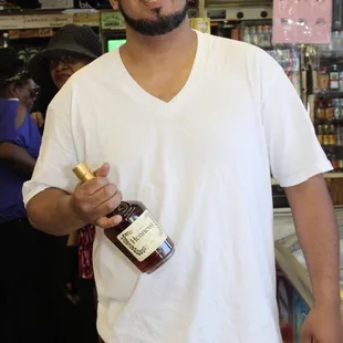 a man holding a bottle of liquor