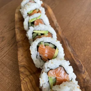 a sushi roll with salmon, avocado, and avocado