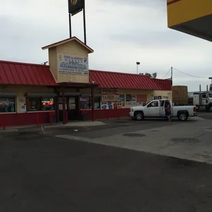 a white truck parked in front of a store