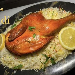 a roasted chicken on a bed of rice