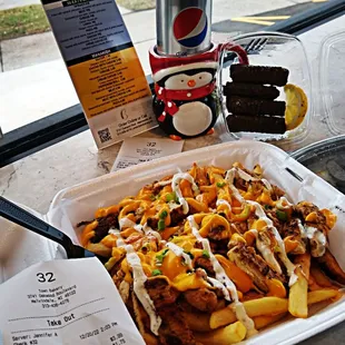 a tray of fries and a can of soda