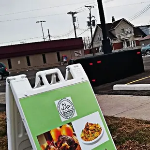 a sign in front of a restaurant