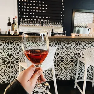 a person holding a glass of wine