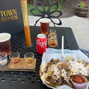 a plate of nachos and a drink