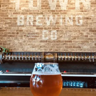 a glass of beer on a bar