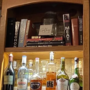a shelf full of liquor bottles