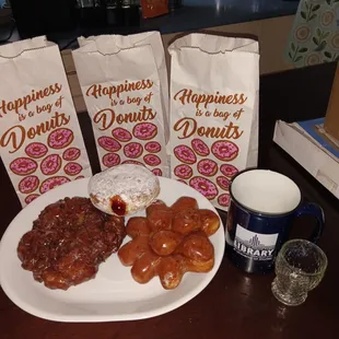 Apple fritter, strawberry jam filled powdered donut and a donut &apos;pine cone&apos;