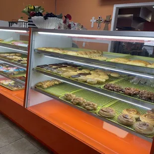 Front counter with donuts and sandwiches on display.