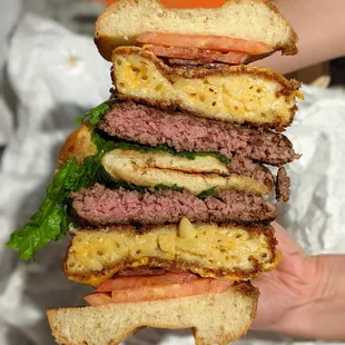 Mac &amp; Cheese Burger. Certified Angus Beef patty, fried mac &amp; cheese, American cheese, applewood smoked bacon, lettuce, tomato, brioche. $12.