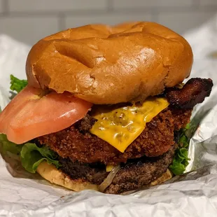 Mac &amp; Cheese Burger. Certified Angus Beef patty, fried mac &amp; cheese, American cheese, applewood smoked bacon, lettuce, tomato, brioche. $12.