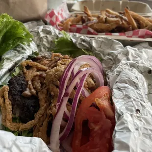 Black bean burger with fried onions, LTO and sautéed onions and mushrooms on lettuce