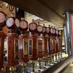 a row of clocks and trophies