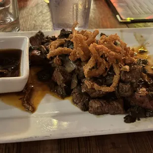 Tenderlion Bites $17 Blackened tenderloin, cremini mushrooms and crispy onions. Served with a side of teriyaki glaze.
