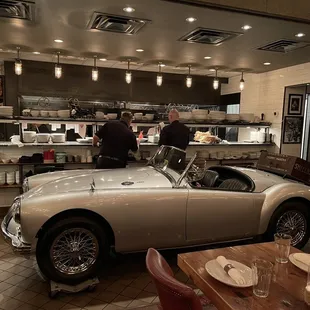 Beautifully restored 1953 MG Spider in front of the kitchen