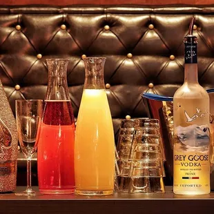 a variety of drinks on a bar counter
