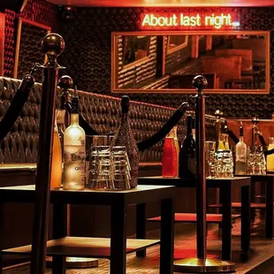 a row of booths with bottles on them