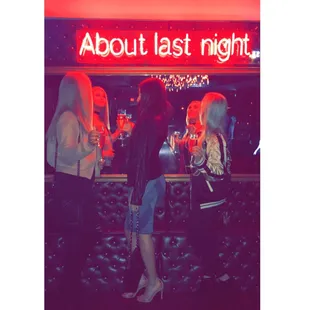 three women sitting at a bar