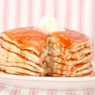 a stack of pancakes with butter and syrup