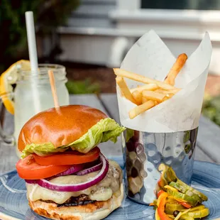 Our Hastings Burger with Aged Cheddar, Lettuce, Tomato, Onion, and House-made Pickles.