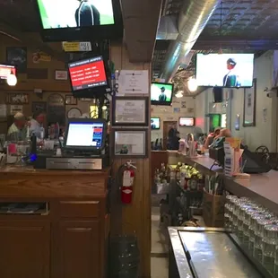 a bar with several televisions on the wall