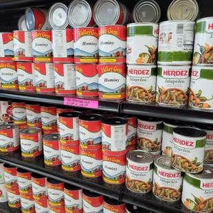 a shelf of canned food in a grocery store