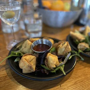 two plates of appetizers on a table