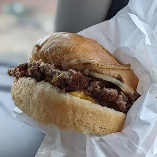 a hand holding a sandwich