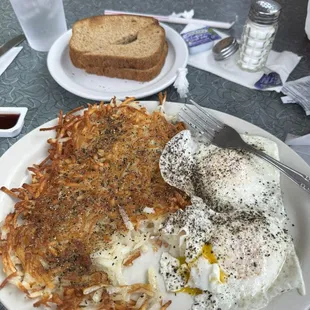 Eggs over easy w/ hash browns &amp; wheat toast.