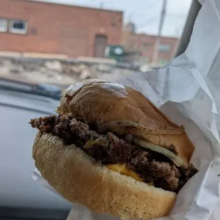 a hand holding a sandwich