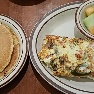The Townee Omelet with Gyros, Feta, Onions, Tomatoes and jalapeños* (*for a surcharge) with fruits and pancakes.