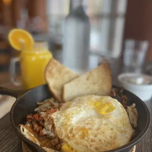 Spanish omelette in a skillet with fresh OJ