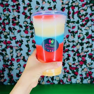 a hand holding a cup of daiquiri