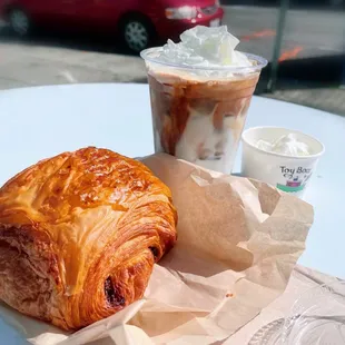 Chocolate croissant; almond milk latte with whip; pupccino for my boy.