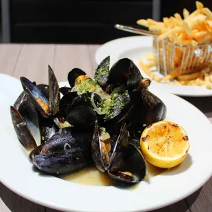 a plate of mussels and fries