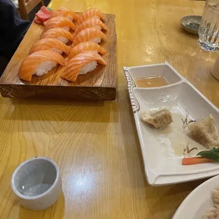 a plate of sushi and rice on a table