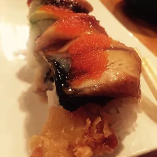 Chef&apos;s creation - shrimp tempura and spicy crab inside topped with eel and roe