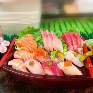 14. The Boat $41.95; Salmon; Tuna; Hamachi (3pcs sashimi); Tekka Maki; Maguro; Hamachi;  Ebi; Unagi; Sake; Tako; Tai; Saba.
