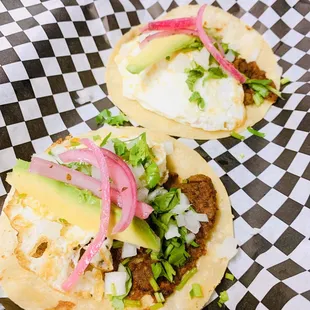 Chorizo and bean taco. With a fried egg, avocado cilantro, and onions.