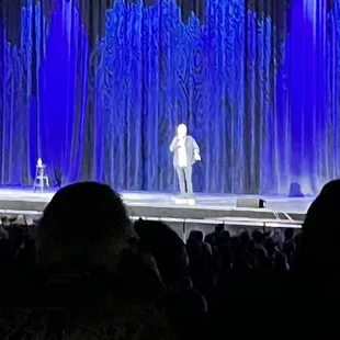 a man on stage with a microphone