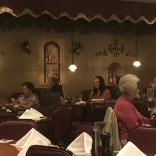 people sitting at tables in a restaurant
