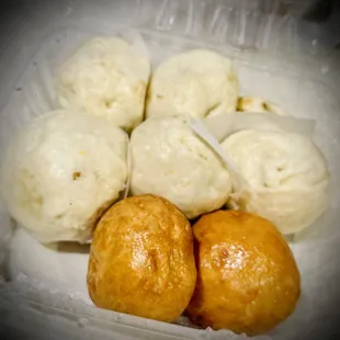 a close up of a plastic container filled with buns