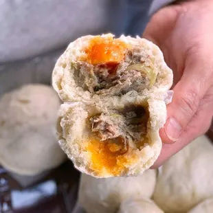 a person holding a piece of food